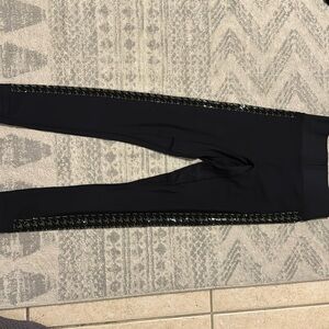 Noli yoga black sports bra and leggings with crystal houndstooth design.